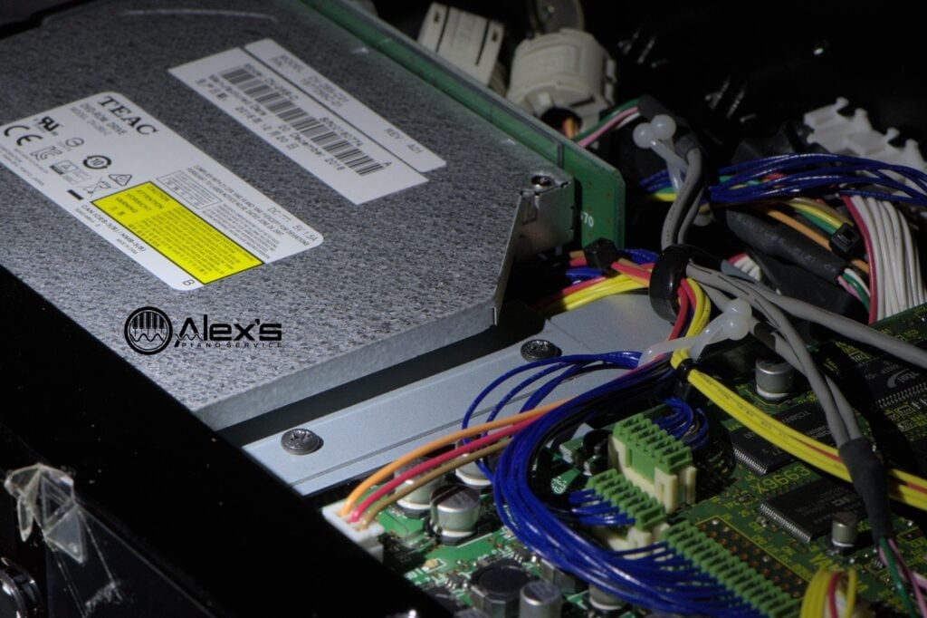 Two of the screws holding the CD drive in place are toward the inside of the case.
