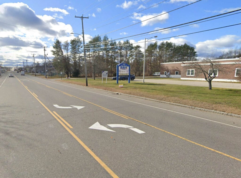 Approaching 432 Elm St. from Five Points in Biddeford. There's a large blue exterior sign.