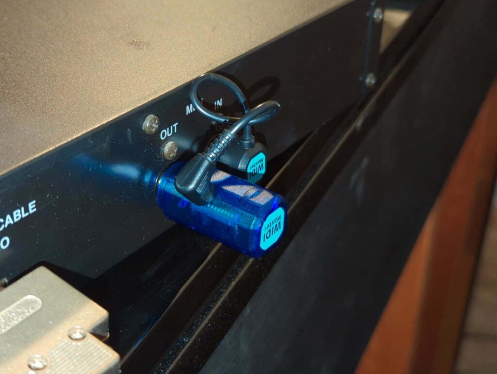 A WIDI Master plugged into the back of a DKC-500RXG.