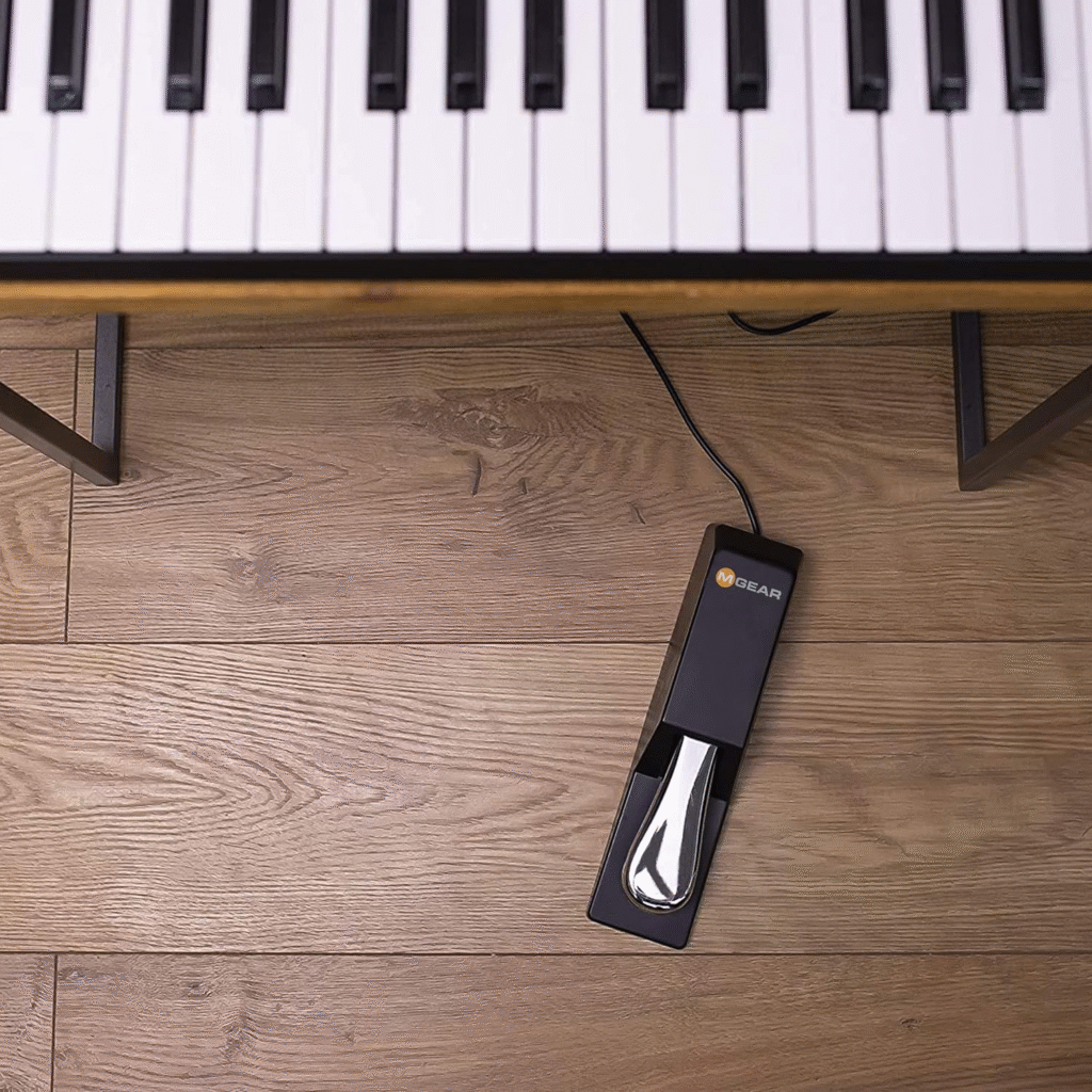 The M-Audio SP-2 sustain pedal, displayed underneath a keyboard.