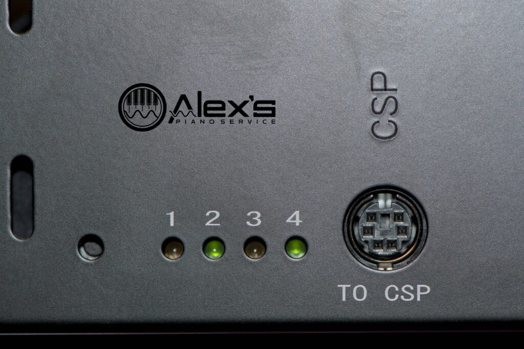 Closeup of Yamaha E3 Power Supply test lights, with lights #2 and #4 powered on and green.