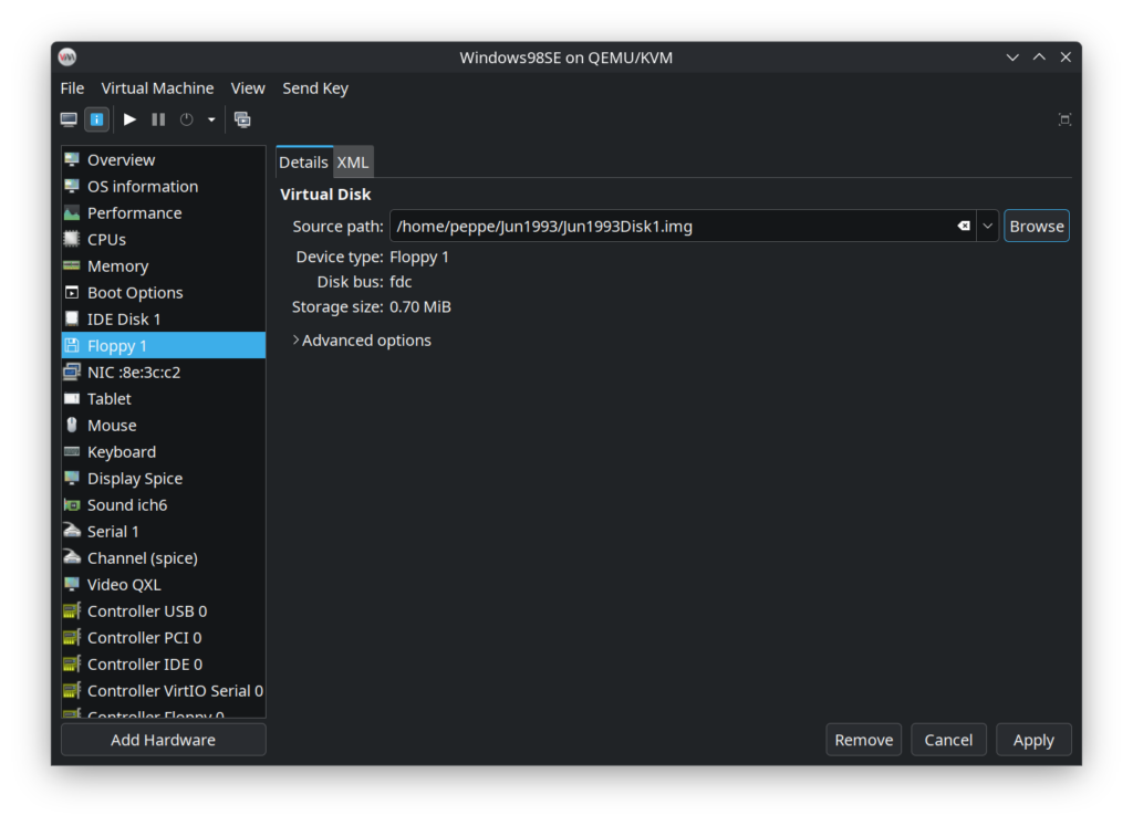Inserting a floppy disk into a Windows98SE VM.