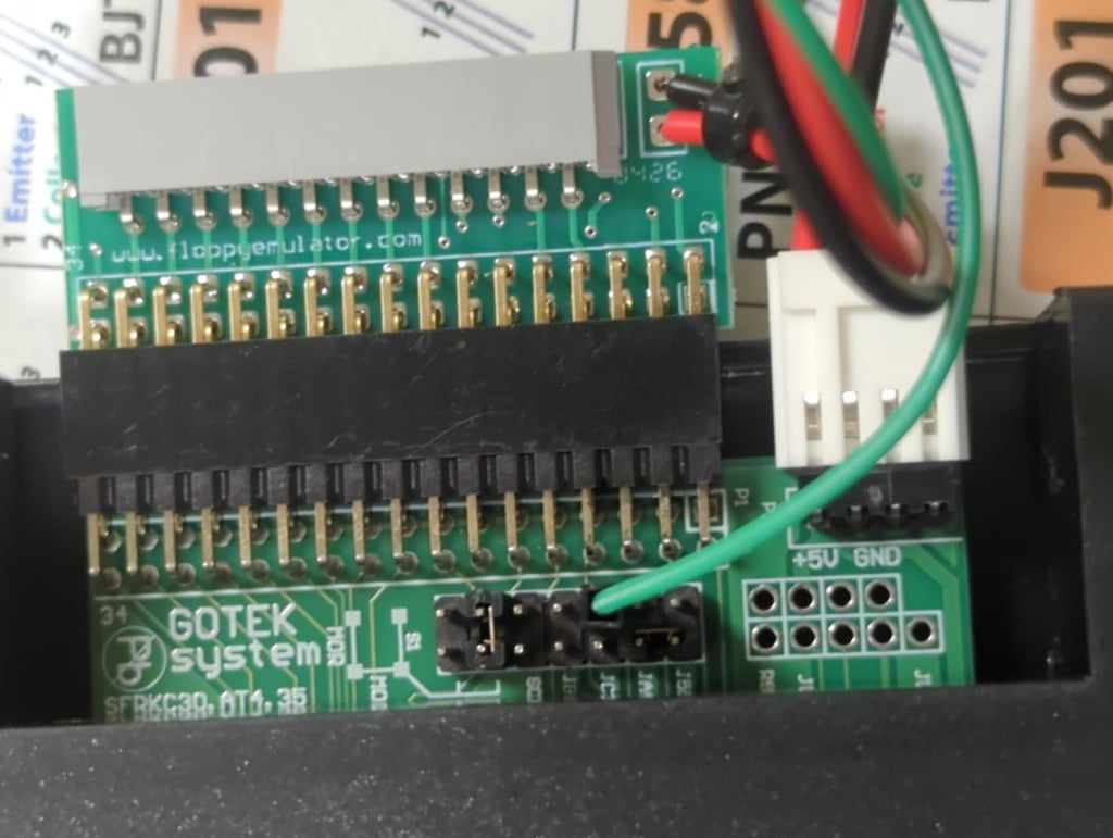 Closeup of Gotek, FlexiDrive adapter, and jumper cable.